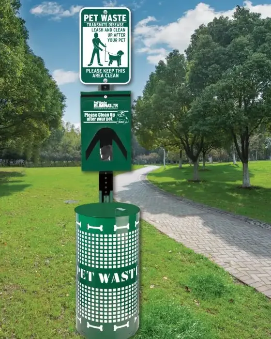 Commercial pet waste station with bag dispenser and trash bin beside a shared property walkway